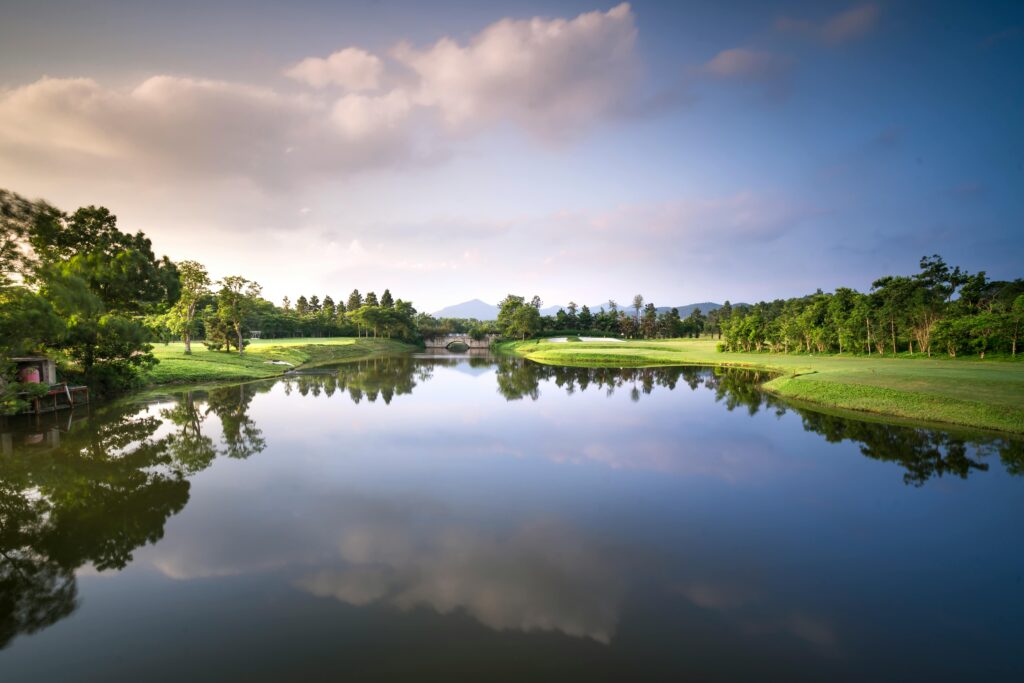 pexels-photo-2172499-2172499 Peaceful golf course landscape with a reflective lake and serene surroundings.